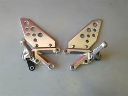 Footrest left Aprilia Tuono 1000